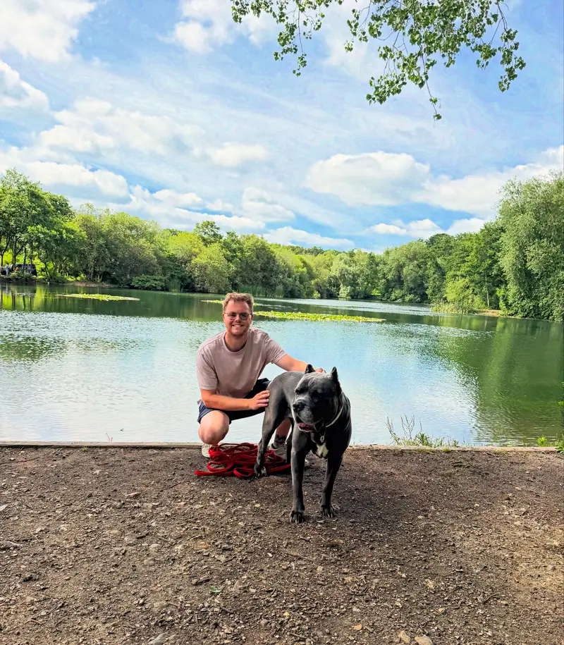 Pete sitting by the water with Ghosty beside him